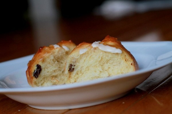 two hot cross buns in a white plate.